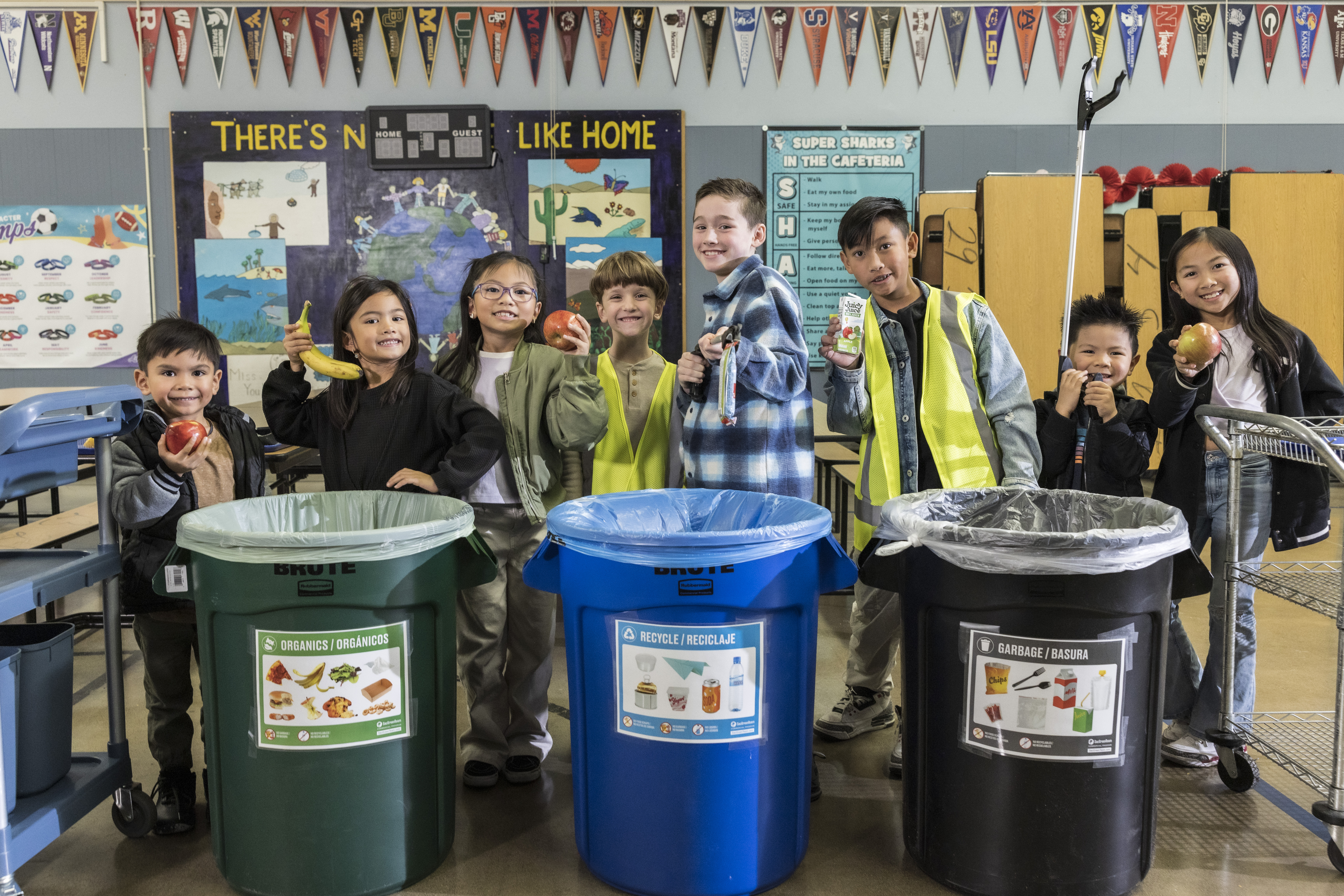 Students posing next to School Cafeteria Waste Sorting Station